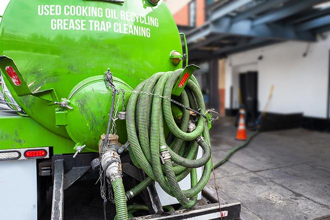 heavy-duty vacuum truck pumping out a grease trap in Juliaetta